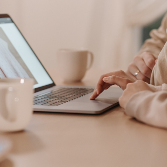 working on computer with coffee mug