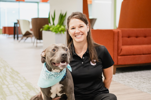 Craft team member posing with their dog and smiling