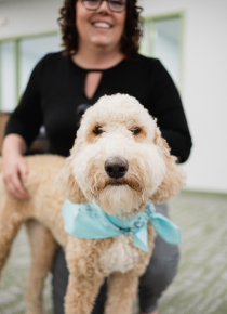 Craft team member posing with their dog and smiling