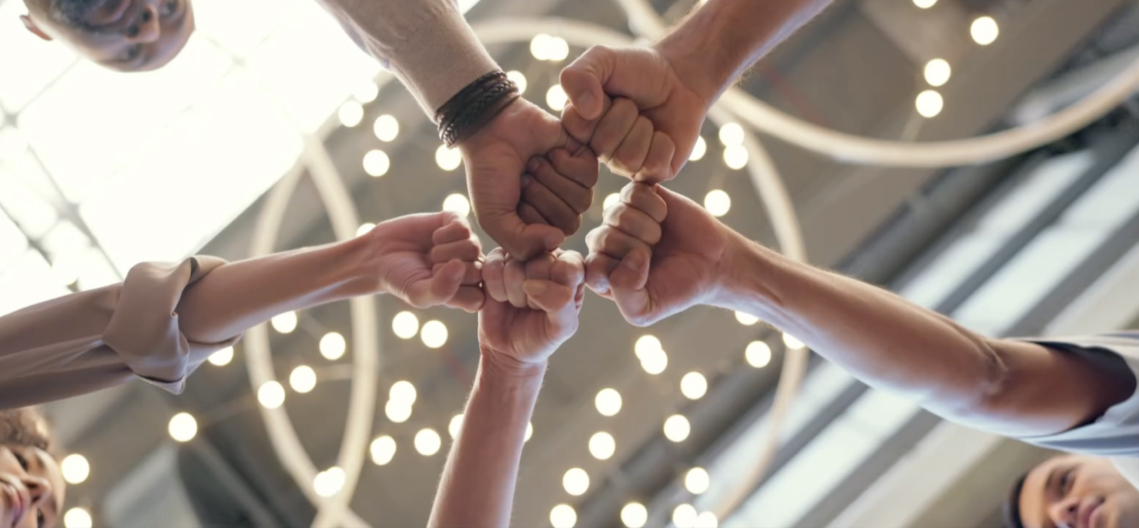 Hands fist bumping together