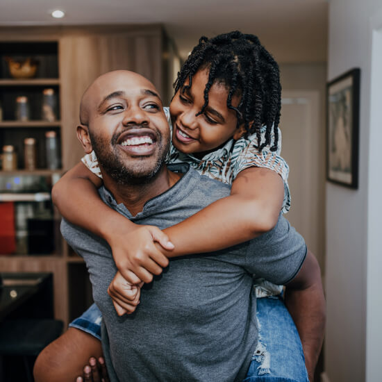 young boy and father smiling