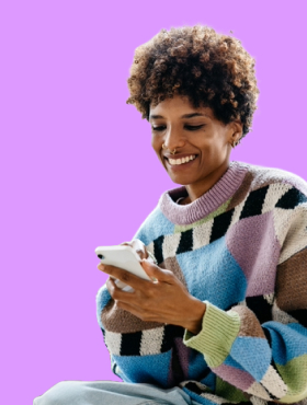 woman smiling while using mobile phone