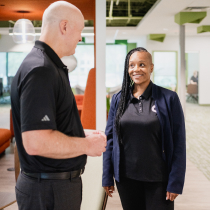 Two Craft team members talking together and smiling